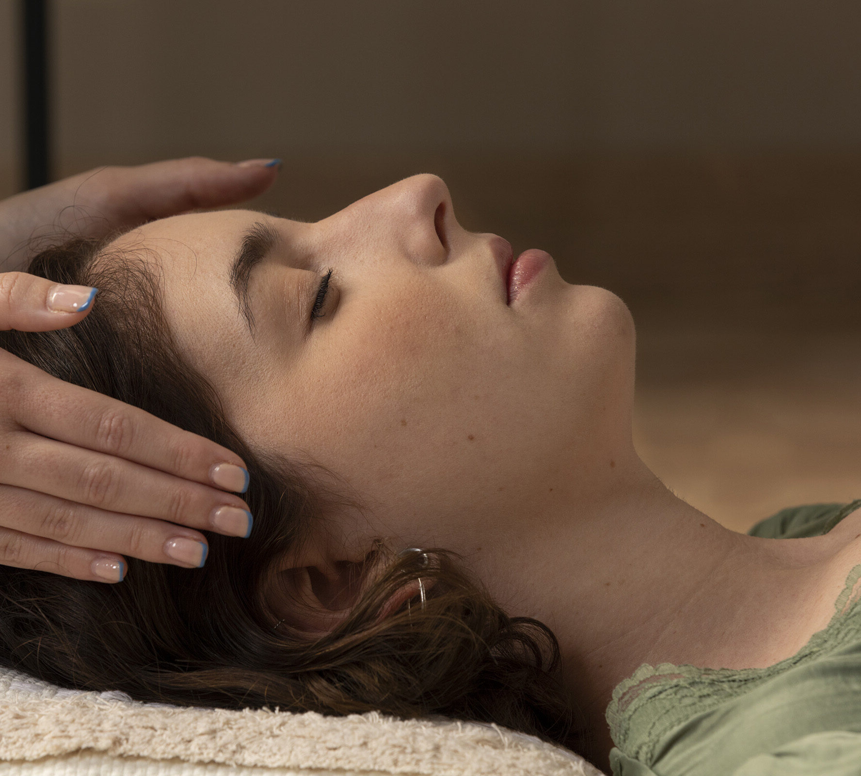 Woman receiving reiki at her crown.